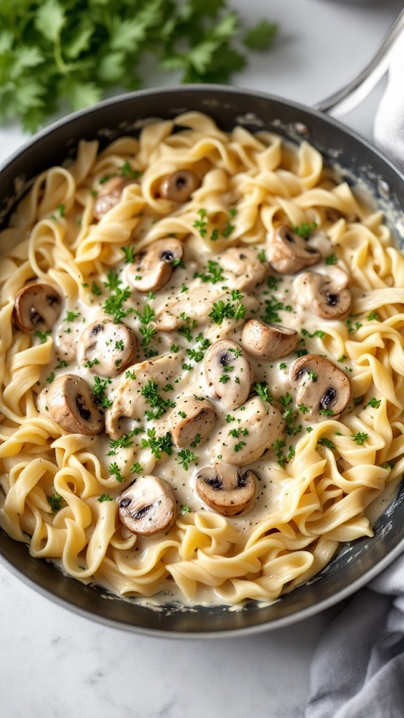 Creamy chicken and mushroom pasta with fettuccine in a skillet